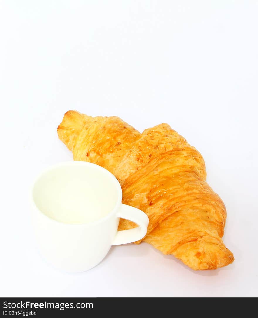 French croissant with empty coffee cup. French croissant with empty coffee cup