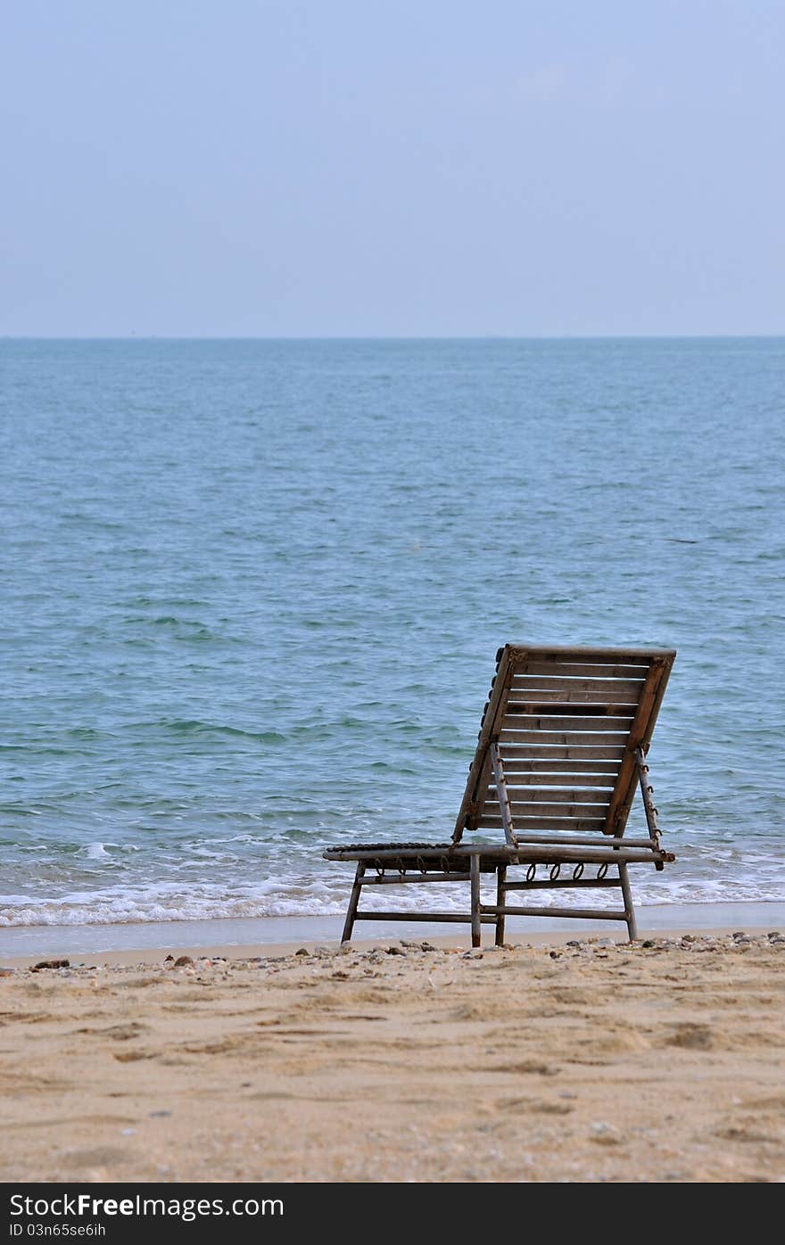 A rest chair on sand beach of sea, shown as spending holidy at sea beach or lonely and calmly stay. A rest chair on sand beach of sea, shown as spending holidy at sea beach or lonely and calmly stay.