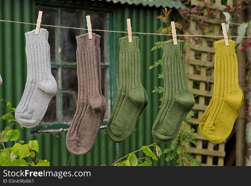 Irish wool chunky knit ribbed winter socks on a line in a rural setting. Irish wool chunky knit ribbed winter socks on a line in a rural setting