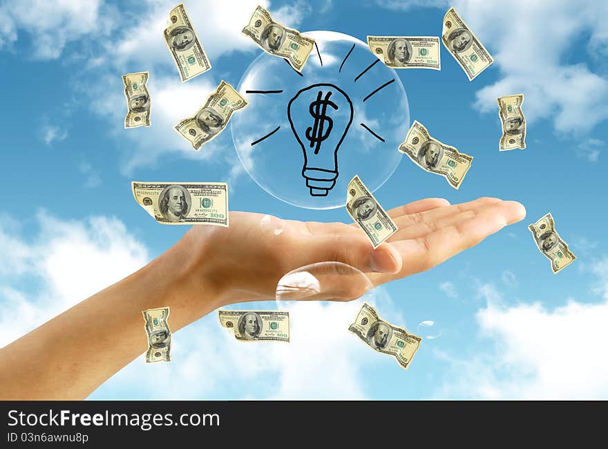 American dollar in hand on blue sky background