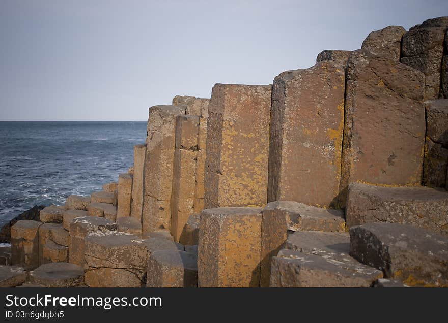 Volcanic stone stone pillars at The Giant's Causeway. Northern Ireland's number 1 tourist attraction, on the beautiful Antrim Coast. Volcanic stone stone pillars at The Giant's Causeway. Northern Ireland's number 1 tourist attraction, on the beautiful Antrim Coast