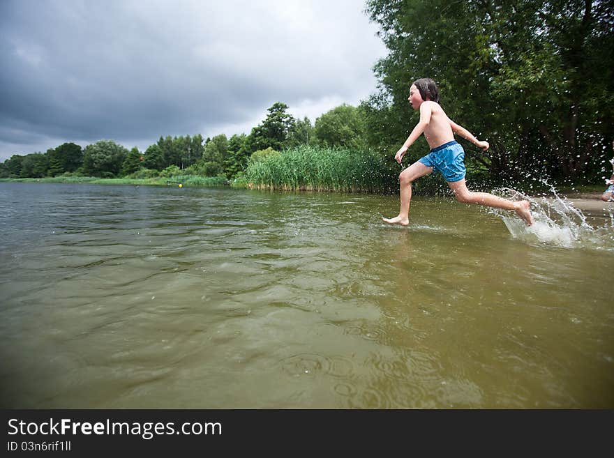 Boy running into a wather. Boy running into a wather