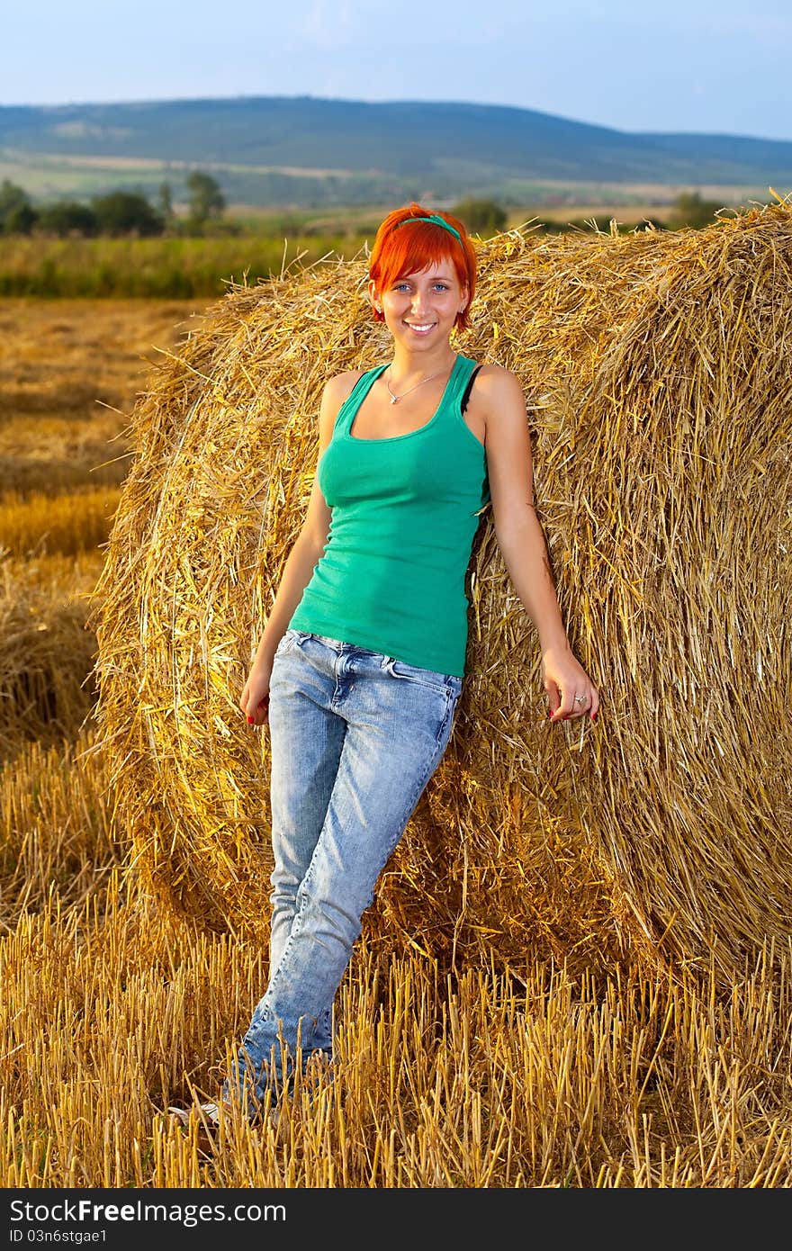 Girl near the straw roll