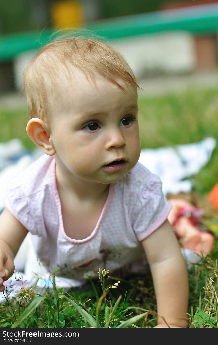 Baby playing on the lawn