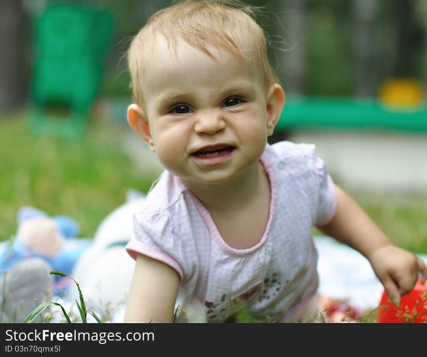 Baby playing on the lawn