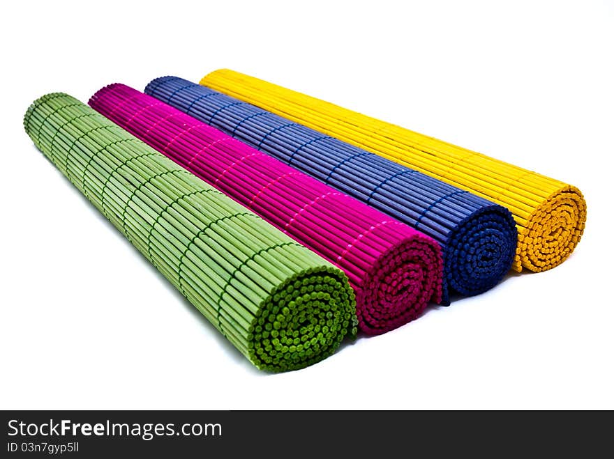 Green, pink, blue and yellow place mats group isolated over white background. Green, pink, blue and yellow place mats group isolated over white background.