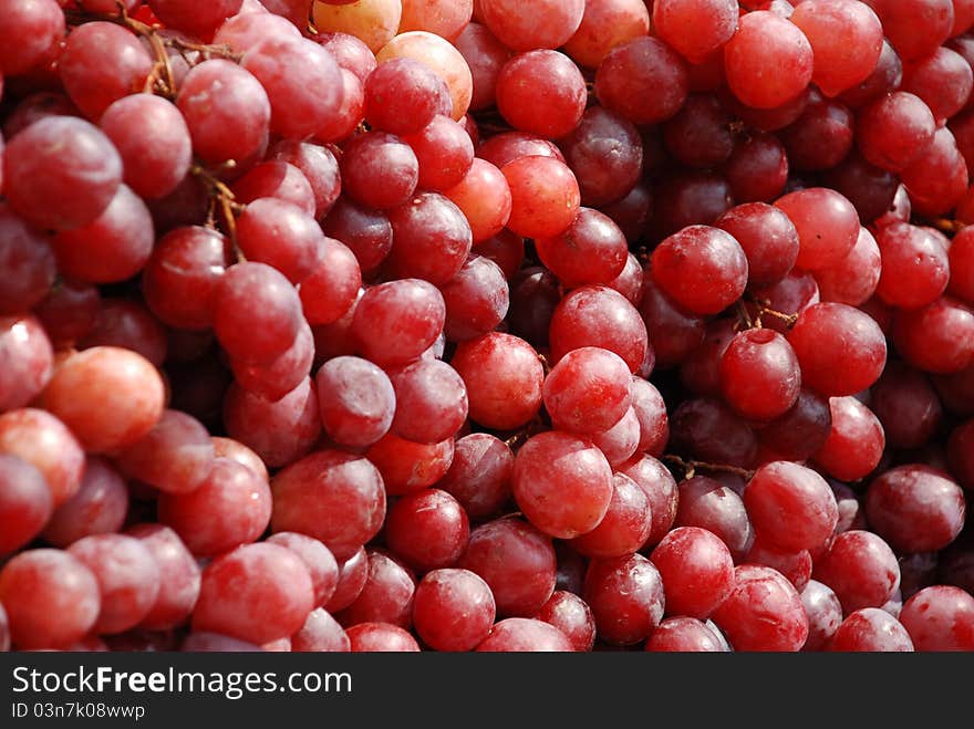 Black grapes on a wood board