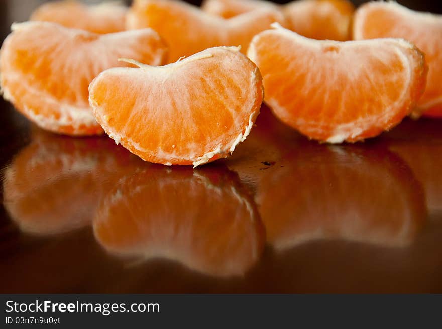 Orange segments оn the wood table