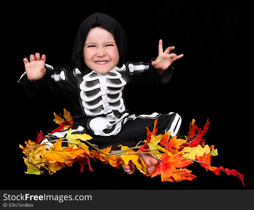 Adorable little boy dressed in scary skeleton costume. isolated on black. Adorable little boy dressed in scary skeleton costume. isolated on black