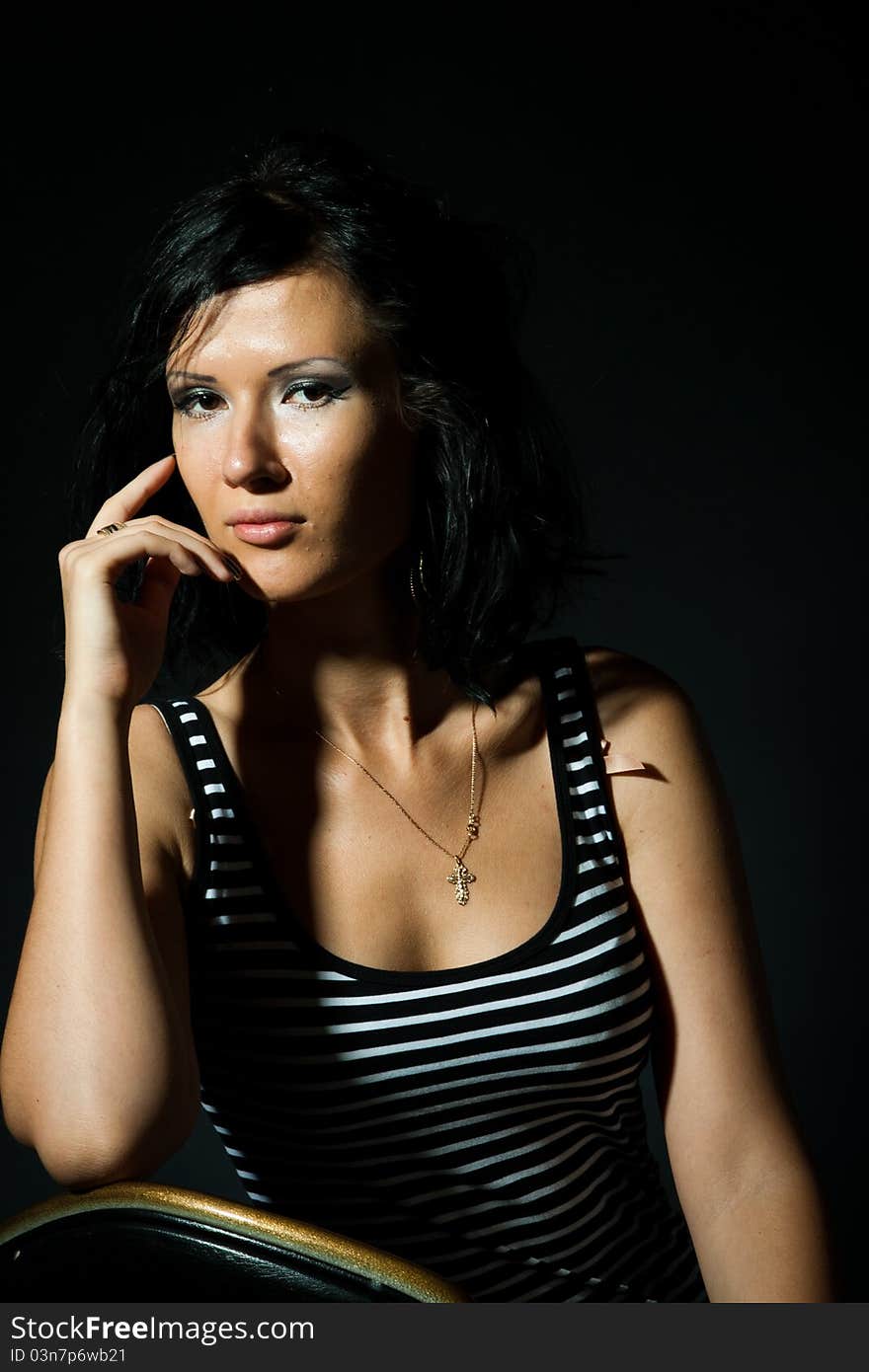 Brunet girl on the black background