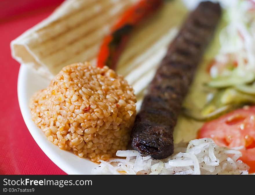 Traditional turkish Adana kebab served with rice, vegetables and lavash. Traditional turkish Adana kebab served with rice, vegetables and lavash