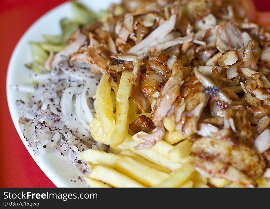 Traditional turkish doner kebab served on white plate with potatoes. Traditional turkish doner kebab served on white plate with potatoes