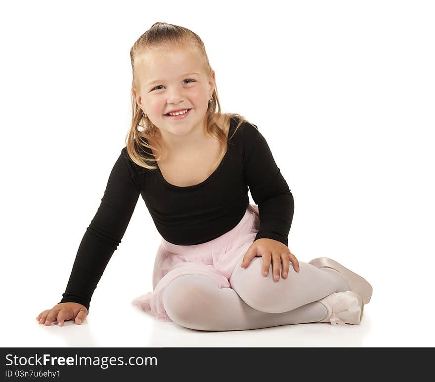 A pretty 3-year-old sitting pretty in her ballerina clothes. Isolated on white. A pretty 3-year-old sitting pretty in her ballerina clothes. Isolated on white.