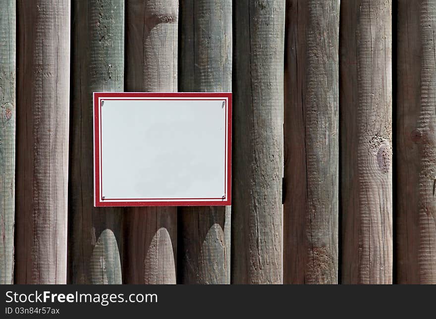 Blank sign on wooden wall.