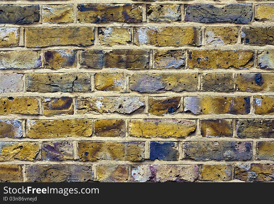 Old brick wall aged with blue spots