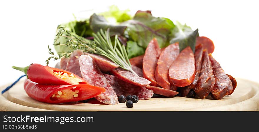 Still life of Spanish traditional sausages Chorizo and Salchichon on white background