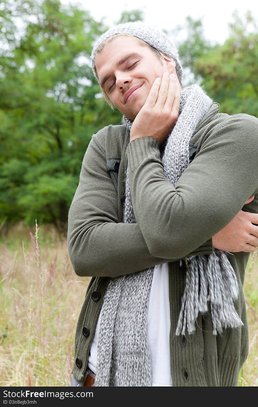 Man relaxing in nature with scarf