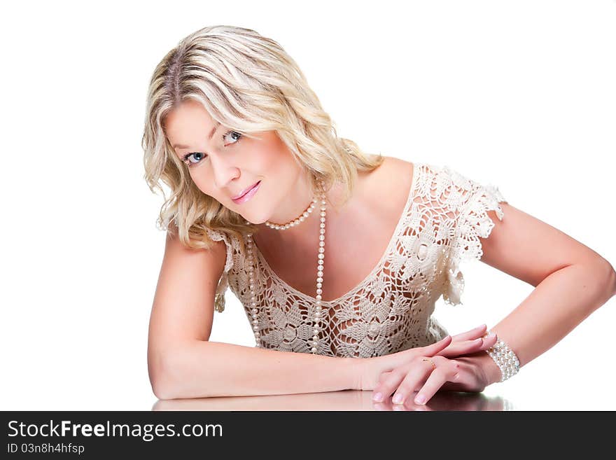 Coquettish blonde woman wearing white knitted lacy