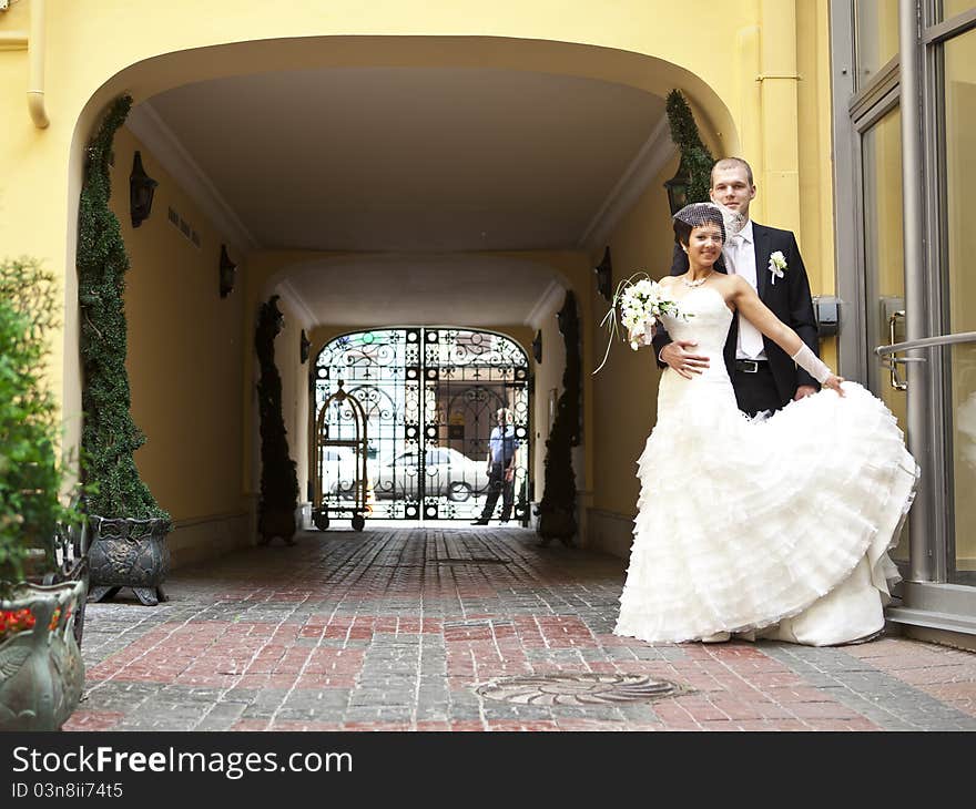 Bride and groom stand and hug. Bride and groom stand and hug