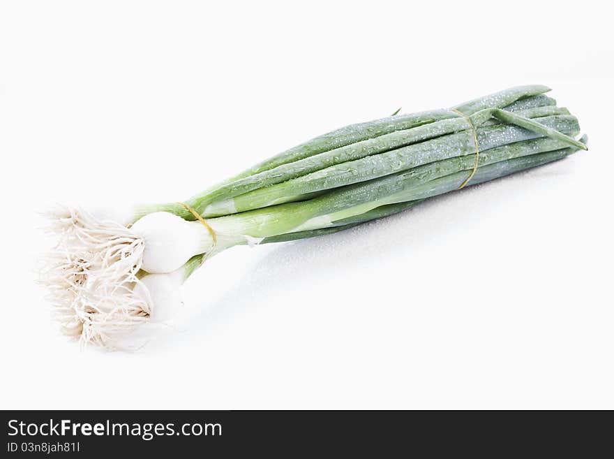 Spring onions on white background