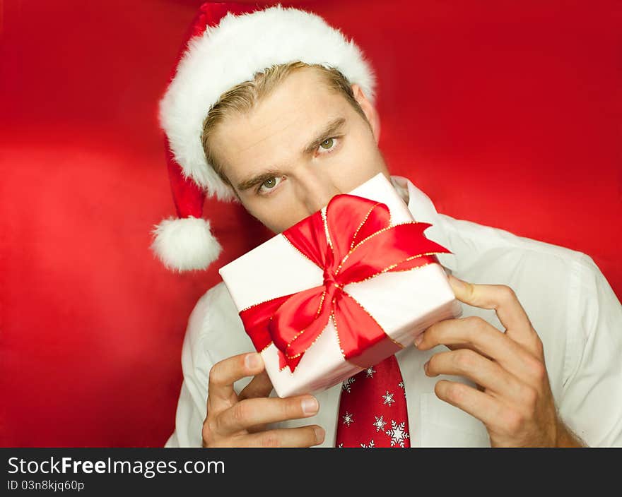 Holding a gift isolated on red. Holding a gift isolated on red