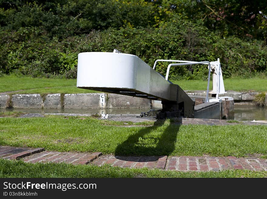 Narrow boat lock handle and walkway. One of many at Caen Hill in Devizes, Wiltshire in the South West of England. Narrow boat lock handle and walkway. One of many at Caen Hill in Devizes, Wiltshire in the South West of England