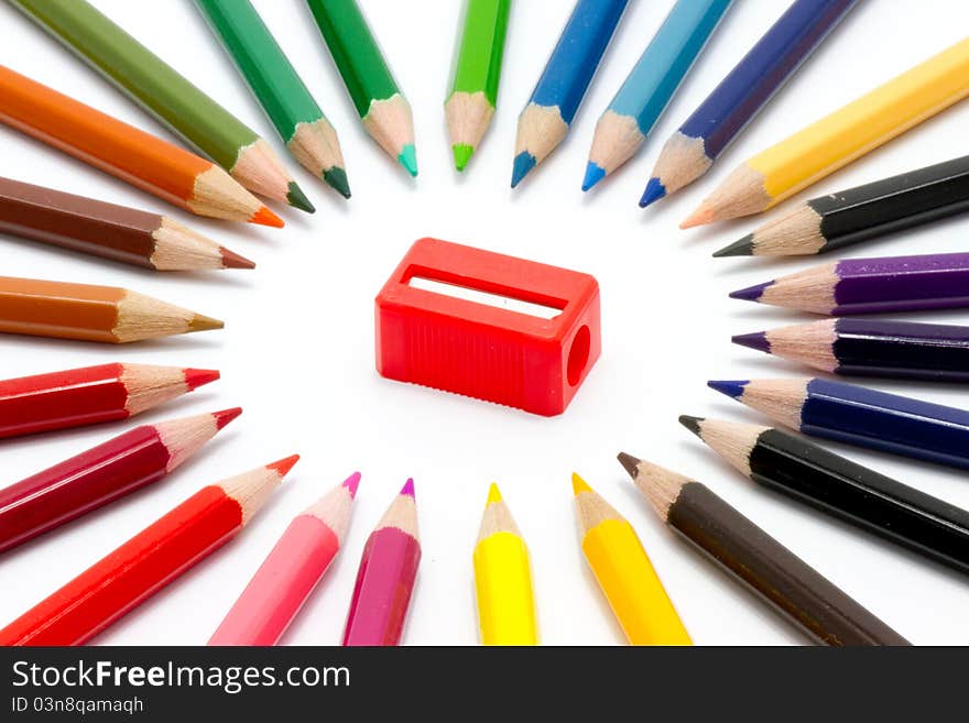 Color pencils and sharpener on white background. Color pencils and sharpener on white background