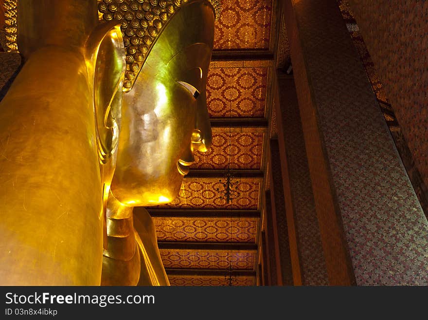 Reclining buddha within the Wat Pho in Bangkok.