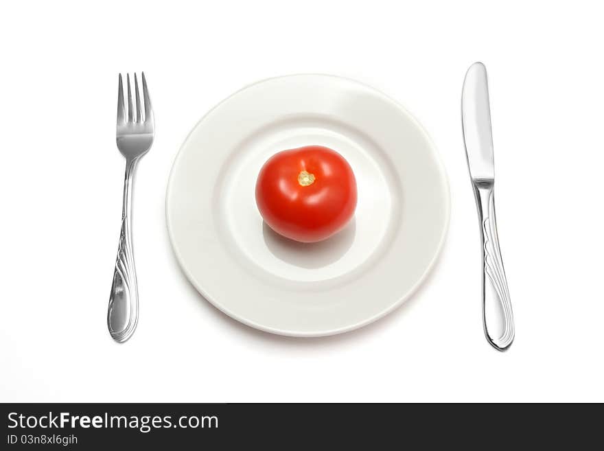 Red tomato on white plate. Red tomato on white plate