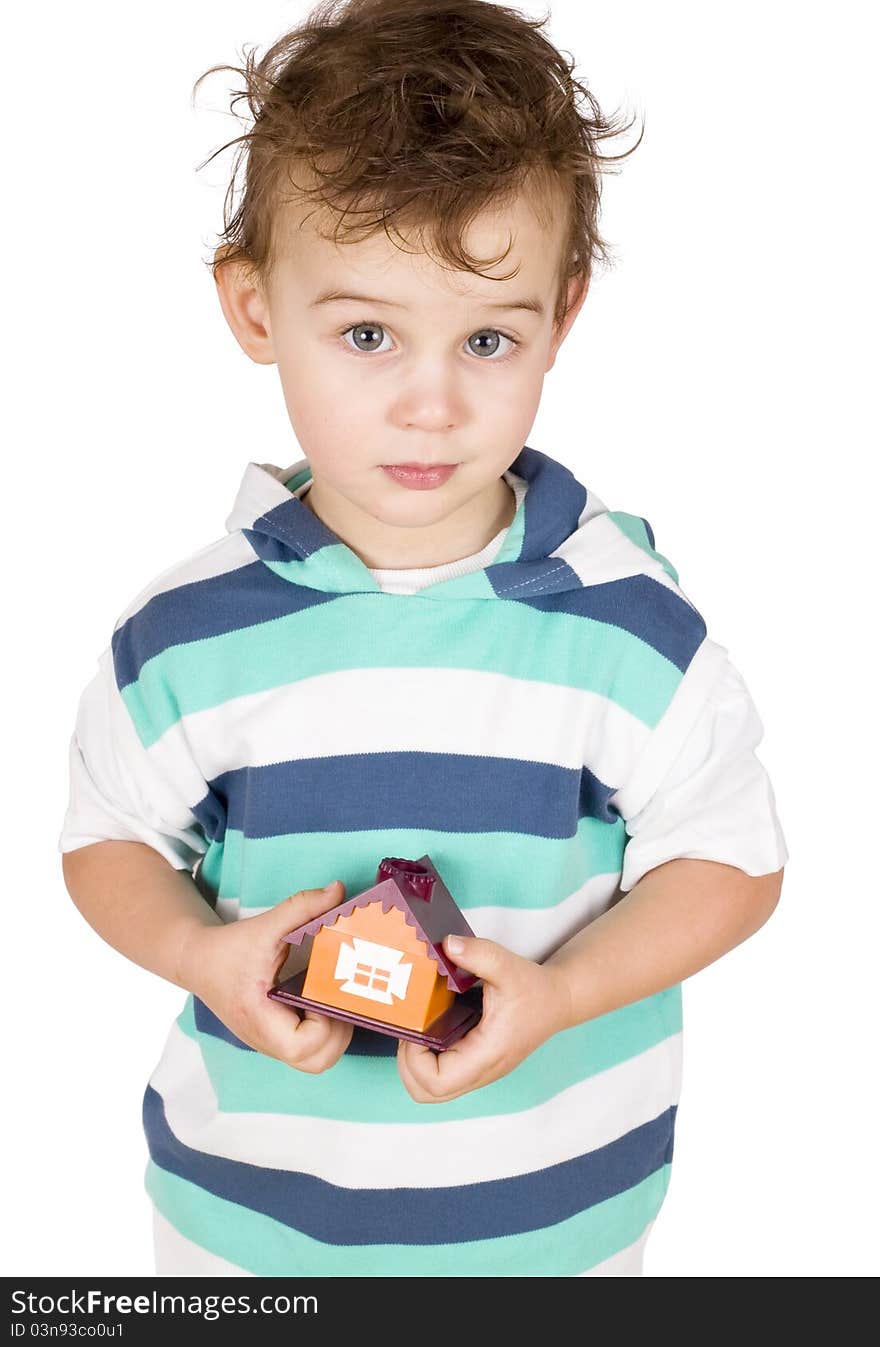 Little boy holding a toy house isolated on white