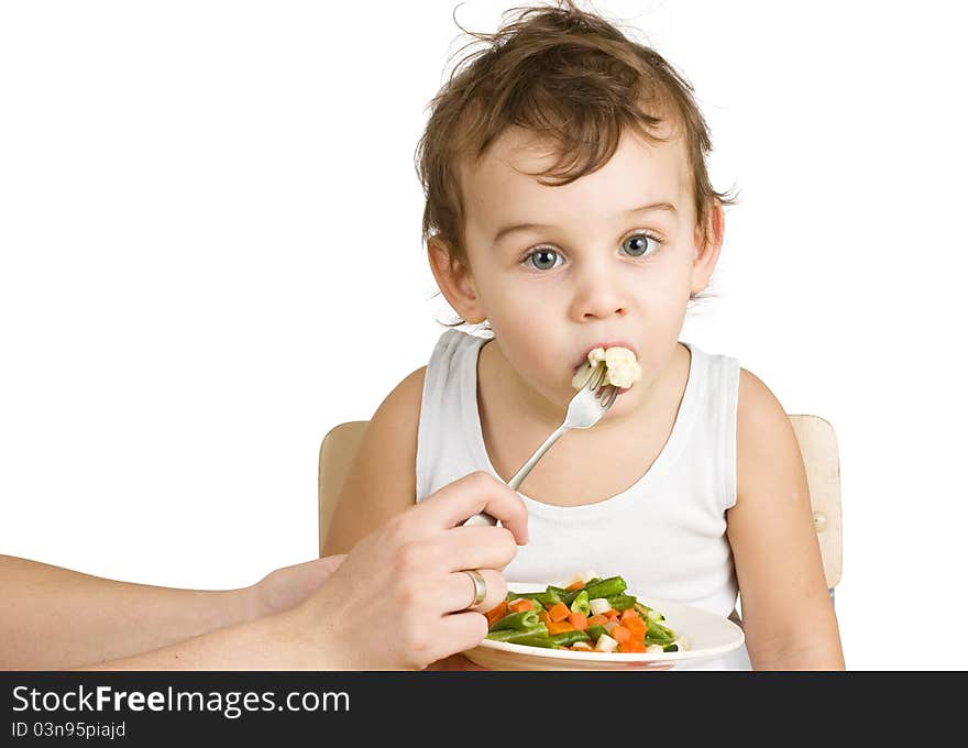 Little boy tasting vegetable salad. Little boy tasting vegetable salad