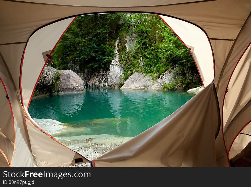 View looking out of door of sun-filled tent upon great outdoors. View looking out of door of sun-filled tent upon great outdoors