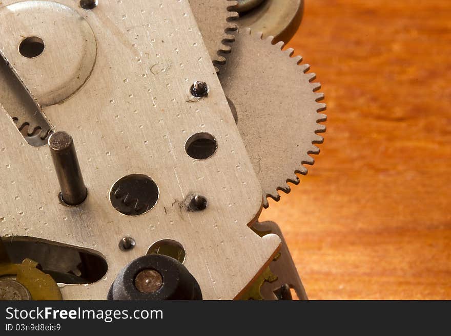 Silver gear mechanism on an orange background.