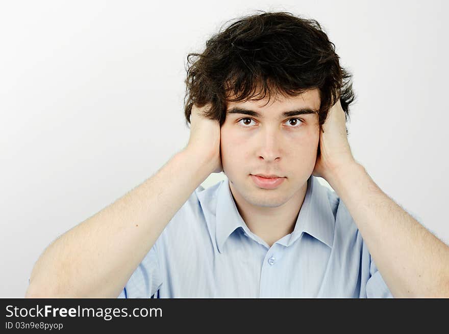 An image of a worker with his ears closed. An image of a worker with his ears closed