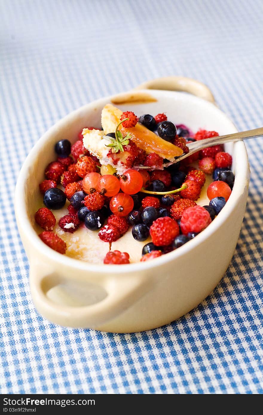 Small pot with cheesecake and wild berries. Small pot with cheesecake and wild berries