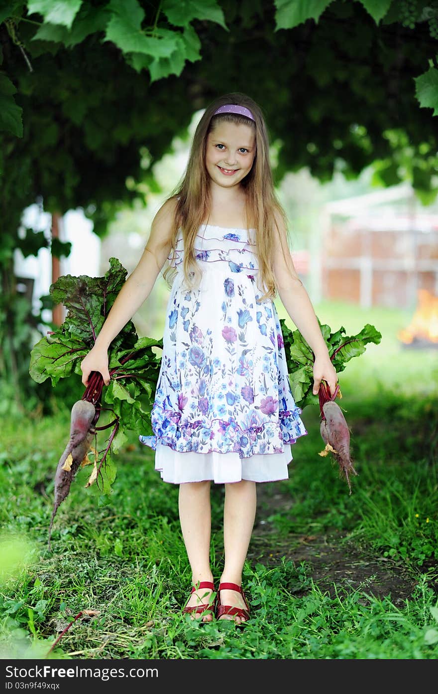 An image of a little girl with beetroots