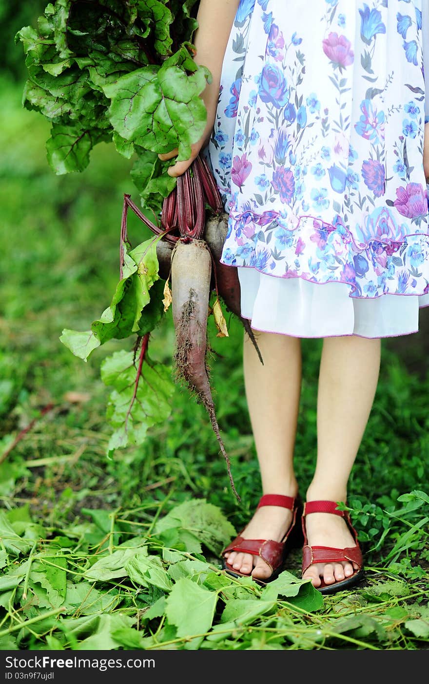 An image of a little girl with beetroots