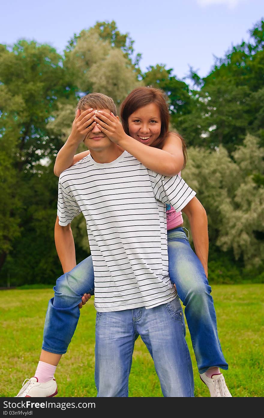 Girl closing her boyfriend eyes by hands