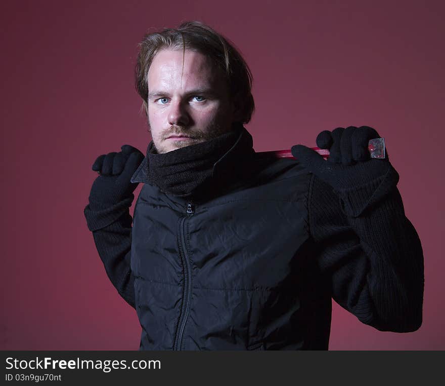 Burglar wearing black holding red crowbar