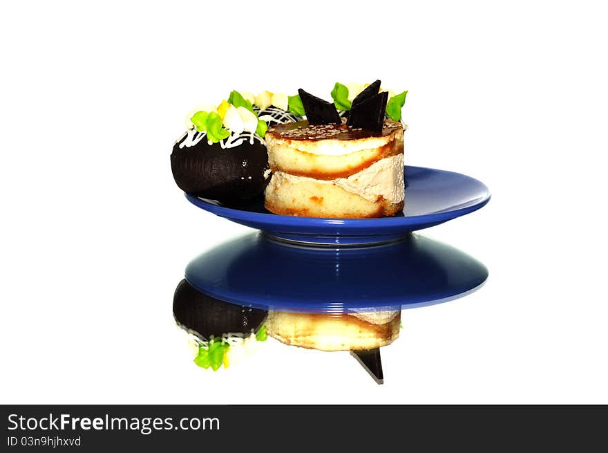 Small cakes with chocolate on a blue plate. Small cakes with chocolate on a blue plate