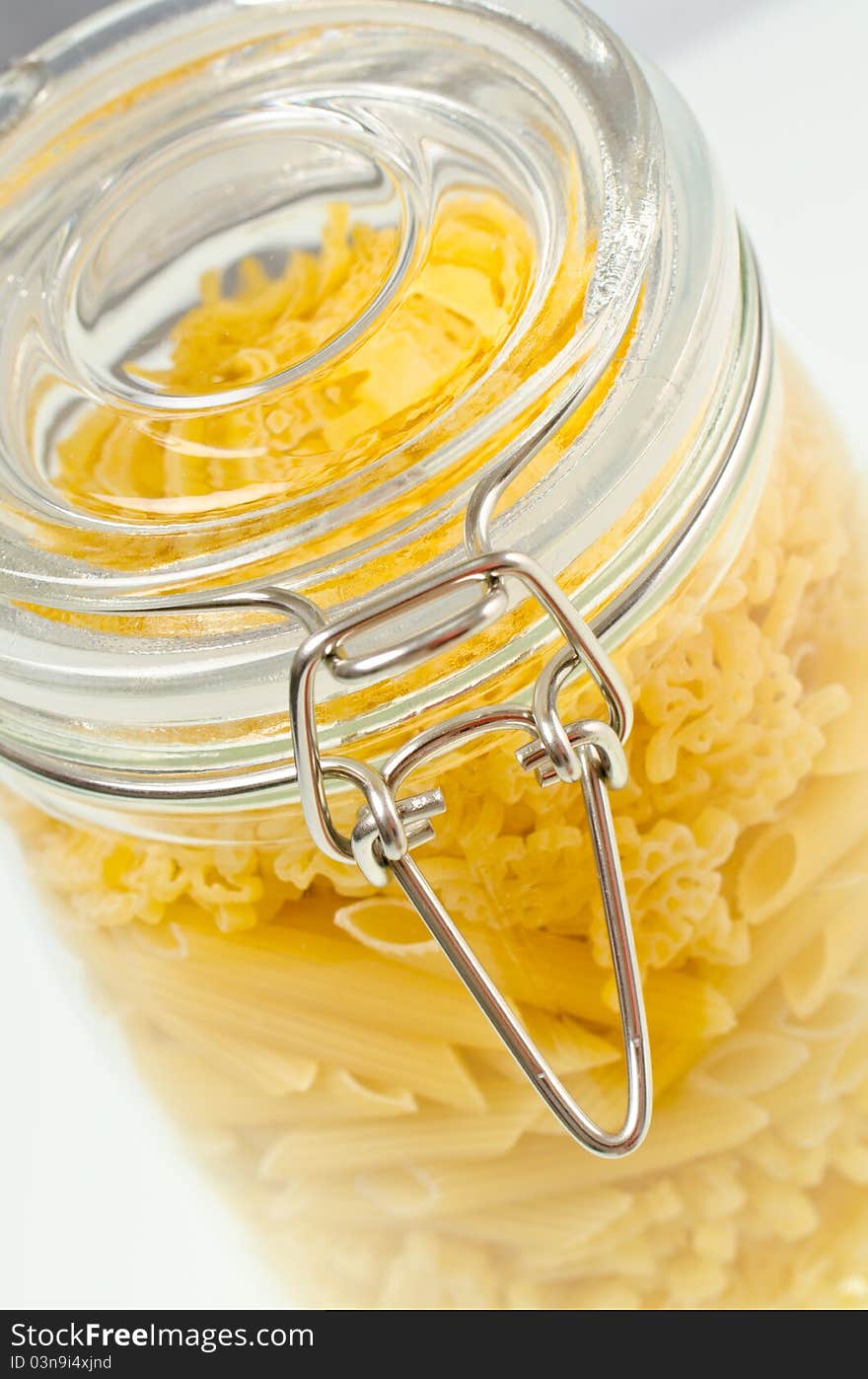 Pasta on glass bowl on a white background. Pasta on glass bowl on a white background