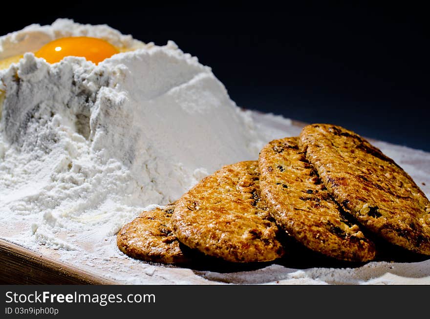 Flour heap and egg on a  wood background. Flour heap and egg on a  wood background