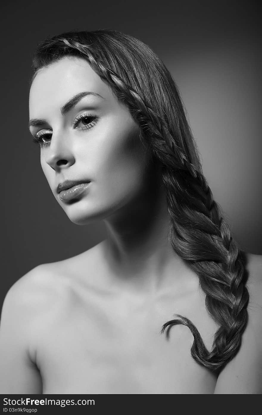 Close-up monochrome portrait of sexy caucasian young woman with beautiful hairstyle on grey background. Close-up monochrome portrait of sexy caucasian young woman with beautiful hairstyle on grey background