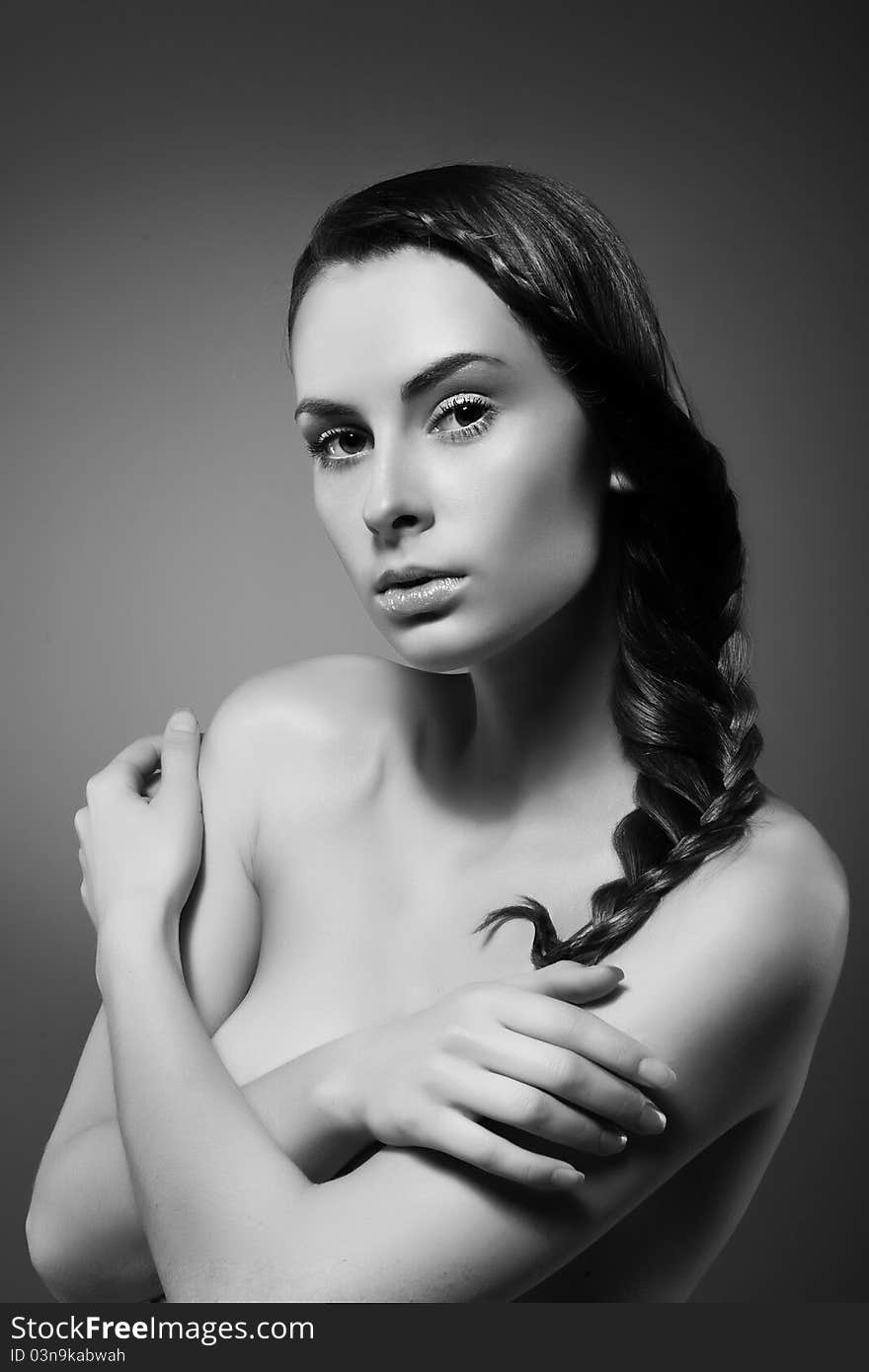 Close-up monochrome portrait of sexy caucasian young woman with beautiful hairstyle on grey background. Close-up monochrome portrait of sexy caucasian young woman with beautiful hairstyle on grey background