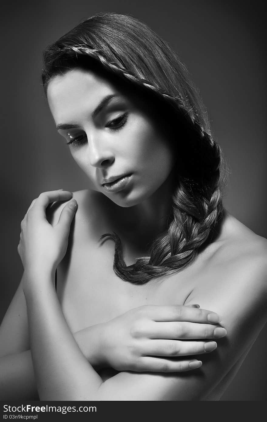 Close-up monochrome portrait of sexy caucasian young woman with beautiful hairstyle on grey background. Close-up monochrome portrait of sexy caucasian young woman with beautiful hairstyle on grey background