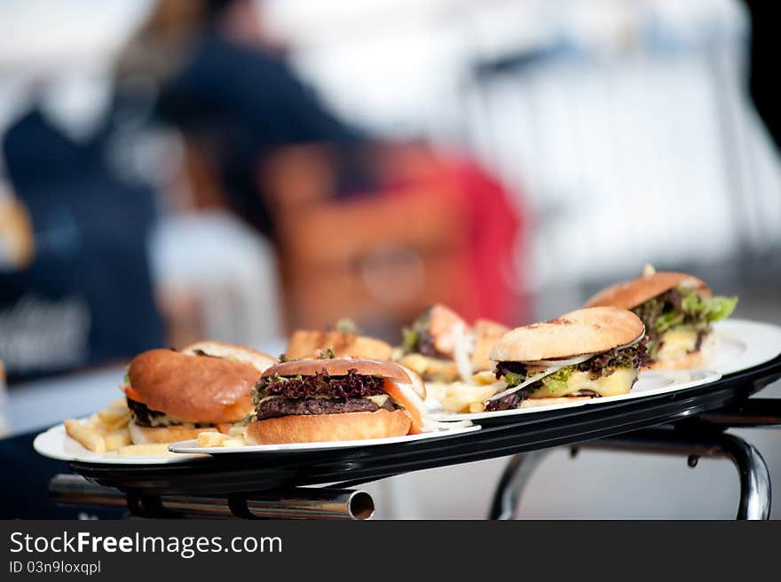 Group of hamburguers served in a tray.