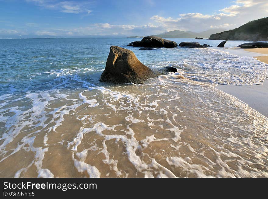 Rocky on sea beach coast under sunset lighting, shown as featured light, color and physiognomy. Rocky on sea beach coast under sunset lighting, shown as featured light, color and physiognomy.