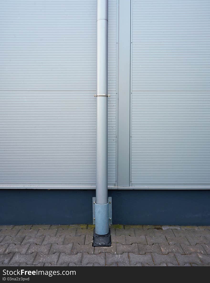 Part of exterior of a warehouse, metal gutter and wall. Modern look.