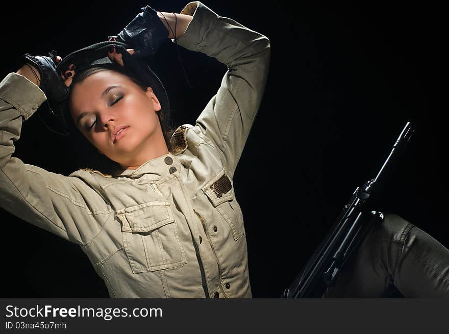 Young beauty girl with machine-gun on black background. Young beauty girl with machine-gun on black background