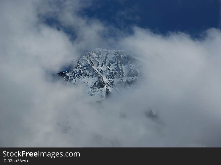 Snow mountain of Jungfraujoch in south of Swiss, very cloudy but just few minutes the peak appear. Snow mountain of Jungfraujoch in south of Swiss, very cloudy but just few minutes the peak appear